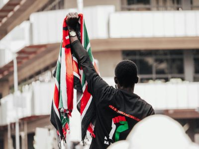 Protestor holding the Kenyan flag during a demonstration in Nairobi's streets.
